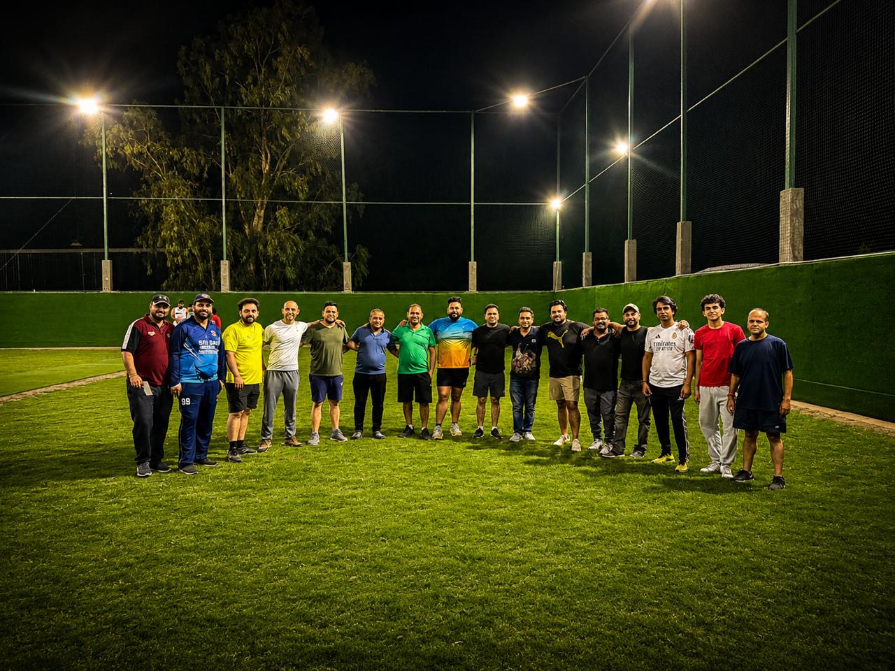 Players at The All Rounder turf under night lights